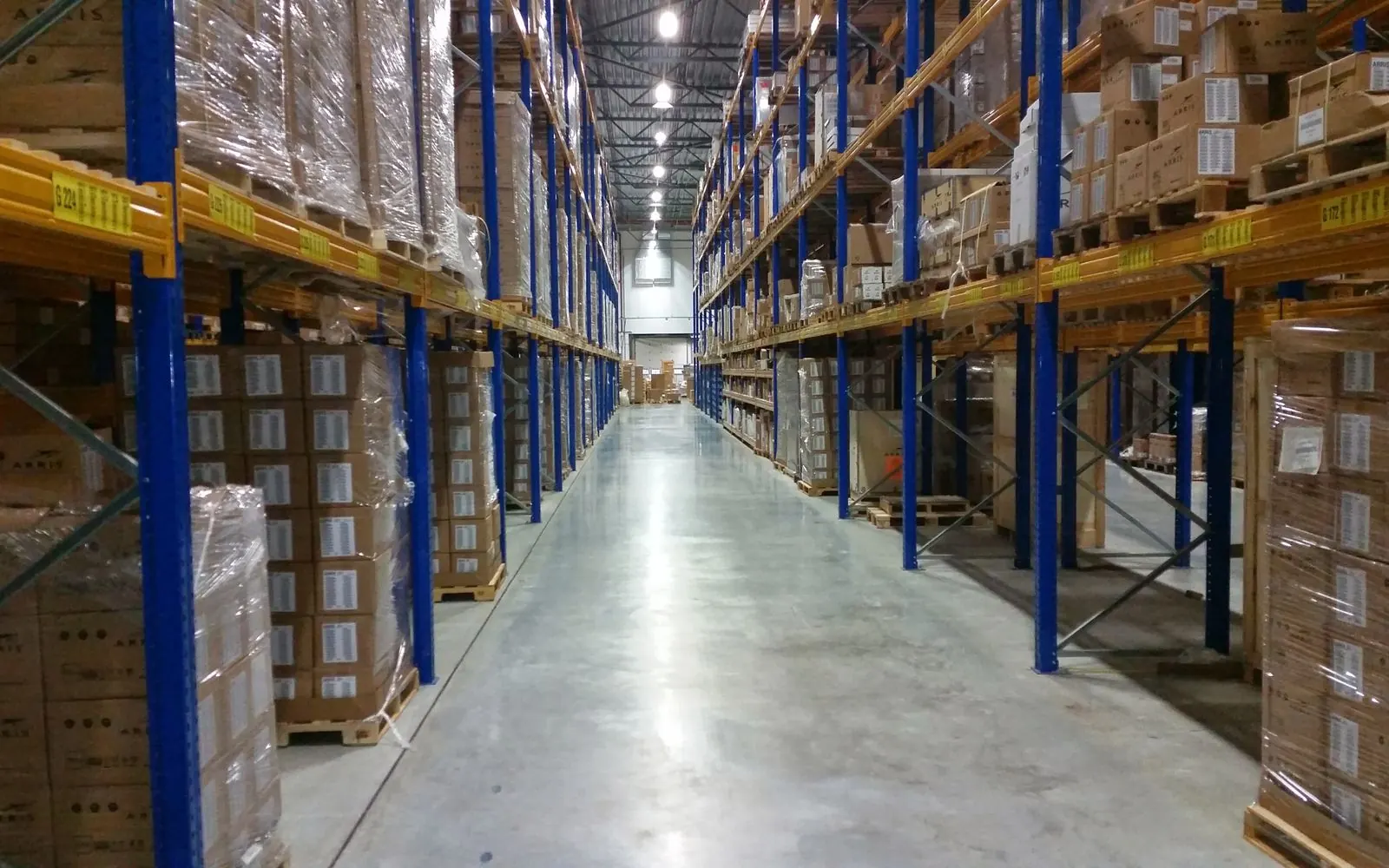 Aisle of a distribution center lined with stacked pallets